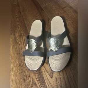 CROCS Women's Sandals with Black Straps and Silver Accents size 9.